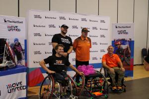 Four individuals in front of a banner