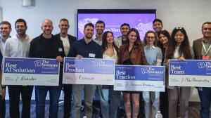 A group of winners stand holding awards as the Ventures announces winners at Tech Week in Boston.