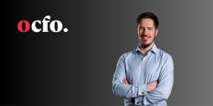 Portrait of Damian Baker, Executive Head of Cloud Accounting at Outsourced CFO, standing with folded arms against a dark gradient background with the OCFO logo.