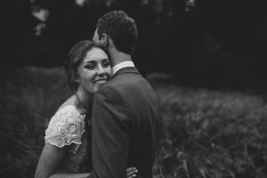Bride hugs her groom during sunset photos at their San Diego wedding.