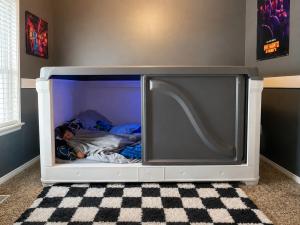 image shows a child sleeping in the safety sensory zPODS inside their room and showing how peaceful the full enclosure zPODS looks like and in the childs room