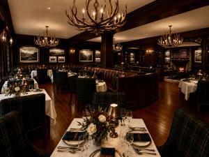 The Velvet Elk rendering will be a lodge-inspired dining room with dark wood, tartan upholstery and antler chandeliers.