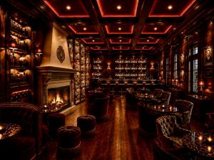 The rendering of the Buffalo Bar shows deep mahogany , tartan clad walls and antler chandeliers