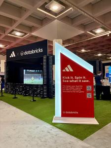 Adidas booth featuring Los Virtuality's interactive Soccer Simulator at the Databricks Data + AI Summit 2026 in San Francisco's Moscone Center.