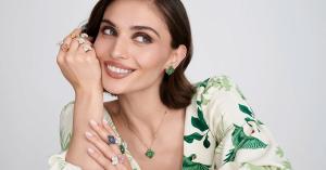 Model wearing Piranesi Fiore Collection flower jewelry featuring sapphire, diamond, and tsavorite rings, earrings, and pendant necklace handcrafted in luxurious Italian fine jewelry.