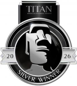 A black, white, and gray logo for the Silver winner of the TITAN Business Awards corporate social responsibility category.