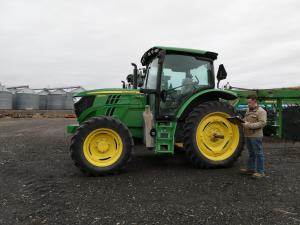 Garrett Schwartz, FASA, CEA, inspecting farm equipment
