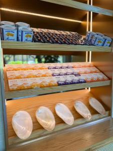 Retail shelves at Fiora’s Bottle Shop featuring caviar pairings, chips, seafood tins, and serving shells