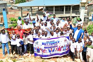Participants pose for a group photo during a walk as part of The Grand Butterfly Gathering in Kibera, Kenya. Photo: Godfrey Atsing'a/The Trueness Project.