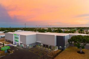 a rendering of a self storage project in sarasota, fl, showing a preserved oak tree on the property