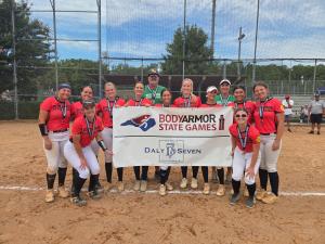 Youth Sports team players celebrate the collaboration between BODYARMOR, North Carolina Amateur Sports, and Daly Seven by holding up a banner.