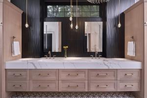ReVision Design + Build bathroom remodel featuring a floating white oak vanity and Cambria Quartz countertops