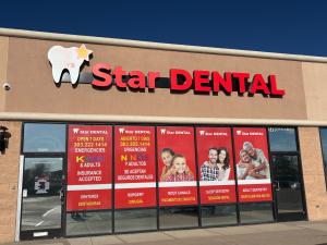 Star Dental storefront in Denver Lakewood with signs for emergency dentistry, kids and adults, dentures, surgery, root canals, and insurance accepted.