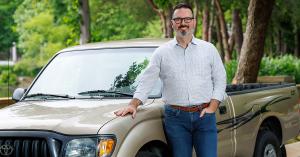 Jeff Hamm, the creator of Banner Elk Living, standing with his old Toyota pickup