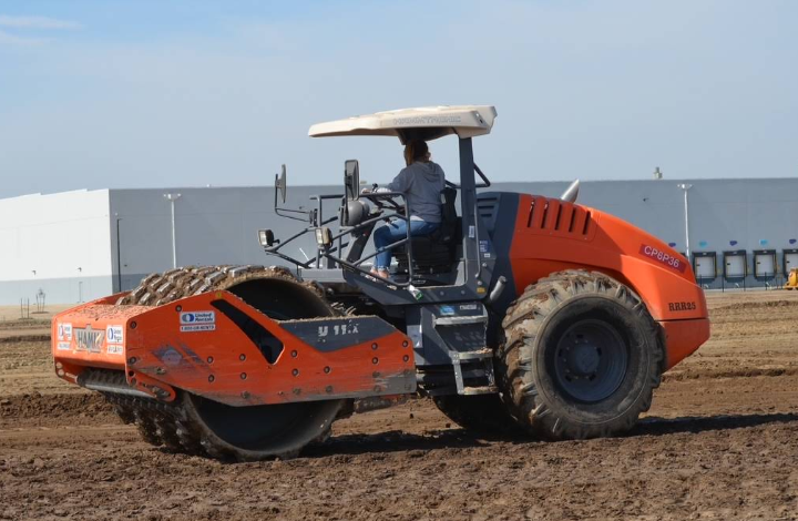 A heavy-duty padfoot roller performing soil compaction during a site grading project for Denny McCowan General Engineering Inc.