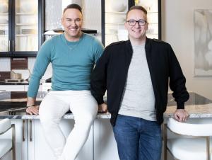 Johnathan and Jon Miller, founders of Jsquared Interior Staging & Design, standing together in a modern luxury kitchen showcasing their interior design and home staging expertise.