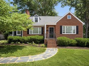 Beautiful brick home in Richmond, Virginia featuring professional landscaping, slate walkway, and enhanced curb appeal prepared by Jsquared Interior Staging & Design.