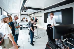 Porsche mobile showcase interior with racing simulator and merchandise display | The Clear Idea