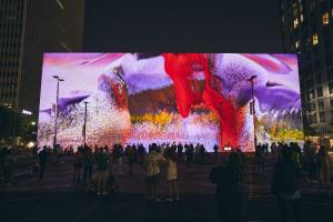 This dynamic AI Data Sculpture exhibits an aesthetic conceptualization of nature-themed data sets in a digital play of light, color, and movement. The work approaches this year’s theme ‘Projected Realities’ by contemplating many meanings of data as a comm
