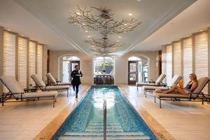 Guests enjoy the luxurious and peaceful indoor Refection Pool with spa dining services at Trellis Spa.