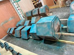 Handmade copper garden containers set up in Halman Thompson's workshop during the bespoke weathering process