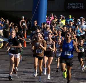 A group of runners (young & old) start the Prefix 5K Fun Run.