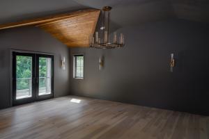 primary bedroom vaulted wood ceiling balcony