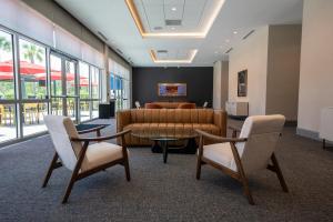 Modern prefunction event space at Home2 Suites by Hilton Fort Walton Beach at Freedom Tech Center featuring contemporary seating, natural light, and direct access to meeting rooms and the outdoor patio.Modern prefunction event space at Home2 Suites by Hil