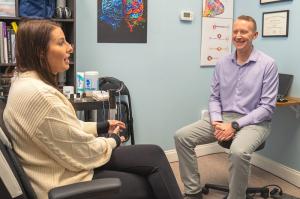Dr. Lars Landers, founder of Restorative Neuro, meets with a patient at the Wellesley, MA clinic
