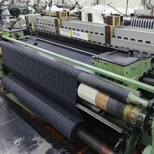 Close-up of a loom weaving ramie fabric at Ryoma's mill