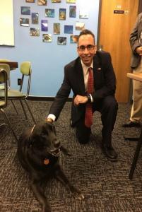 Acting Director Baum visiting drug treatment center in Vermont in 2017 and posing with office dog