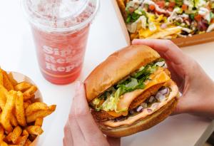 Unburger's Unoriginal Chick'n Sandwich, Kombucha, and seasoned fries.