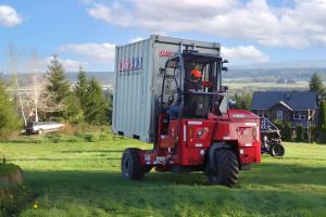 Dry Box Delivering a shipping container with a forklift