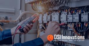 Technician testing an industrial control panel using electrical diagnostic equipment inside a UL 508A-certified panel fabrication facility.
