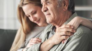 a woman hugging an older man
