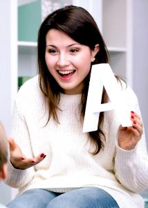 speech therapist holding up the letter A