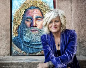 Michelle Larsen, recognized among the Top 60 Masters of Contemporary Art, standing beside her original 3D paper sculpted artwork.