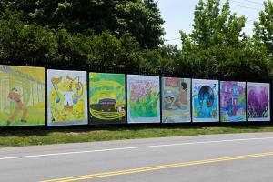 The completed "Echoes Beyond the Stage" mural series by artists Nile Livingston and Devon Downes installed along the entrance gates of the Highmark Mann Center for the Performing Arts in Philadelphia.jpg
