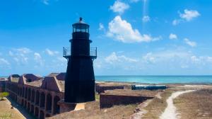 A lighthouse sits on a fortress bastion.