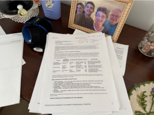 a family frame and documents on top of a desk