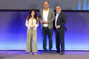 CRM Masters Infotech receiving the AI Enterprise Catalyst Award on stage at an industry event.