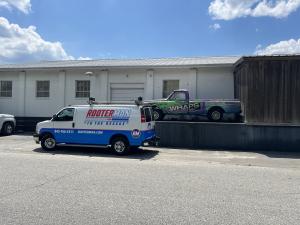 Rooter Man Plumbing service van parked outside a commercial building in Charleston, SC, showcasing the company's branded vehicle wrap and updated fleet.
