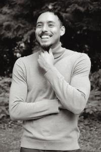 William Iraheta Flores, exclusive buyer's agent at HomeBuyer Brokerage, smiling in a black-and-white outdoor portrait.
