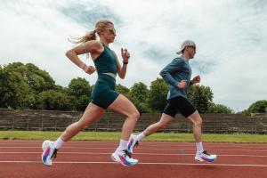 Two runners on the track wearing Topo Athletic Specter Elite