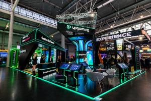 Upgaming exhibition stand at ICE Barcelona 2026 featuring sportsbook and casino software demonstrations with visitors exploring the booth.