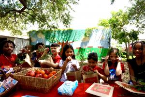 Elementary students tasting what they foraged in the food forest.