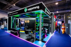 Upgaming exhibition stand at SiGMA South America 2026 in São Paulo featuring branded displays, interactive product demo stations, meeting areas, and LED screens presenting the company's iGaming technology solutions.