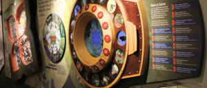 Interactive museum exhibit displaying butterfly and moth species with a circular match game and descriptive species information panels.