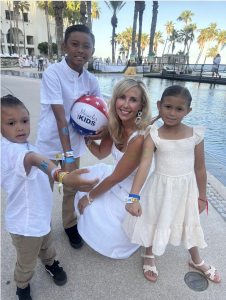 Autumn Strier, Co-Founder & CEO Miracles for Kids, at the 29th Annual Stars & Stripes Tournament with a Miracle Family, pictured are 3 kids with Autumn at the pool about to play