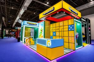 Upgames' branded exhibition booth at SiGMA South America 2026 in São Paulo, featuring colorful stand design, interactive game displays, and mini game demonstrations for casino operators and business partners.